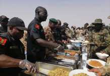 PHOTONEWS: Buratai Violates Social Distancing Rule, Serves Troops Food Without Wearing Nose Mask