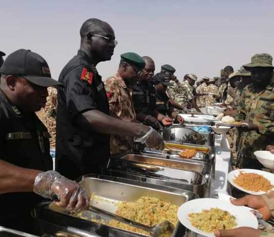 PHOTONEWS: Buratai Violates Social Distancing Rule, Serves Troops Food Without Wearing Nose Mask