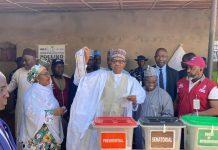 Buhari displays ballot paper after voting in Daura